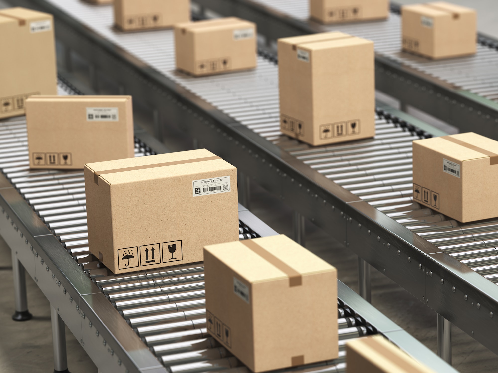 Cardboard boxes on conveyor roller in distribution warehouse, De
