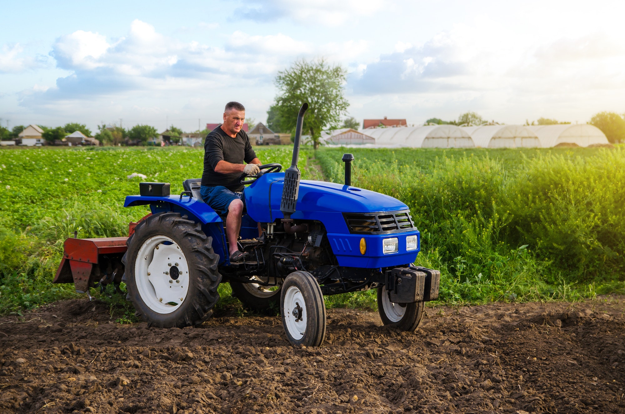 Farmer on a tractor works in the field.