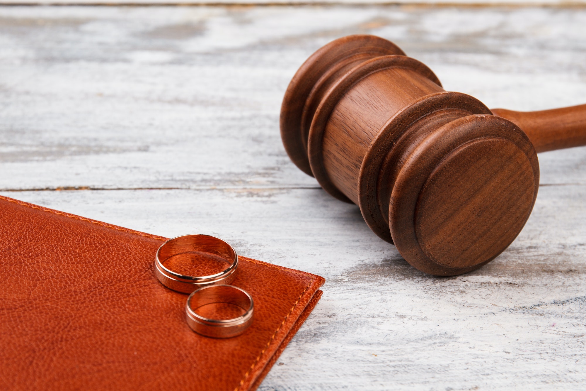 Judge gavel and wedding rings.