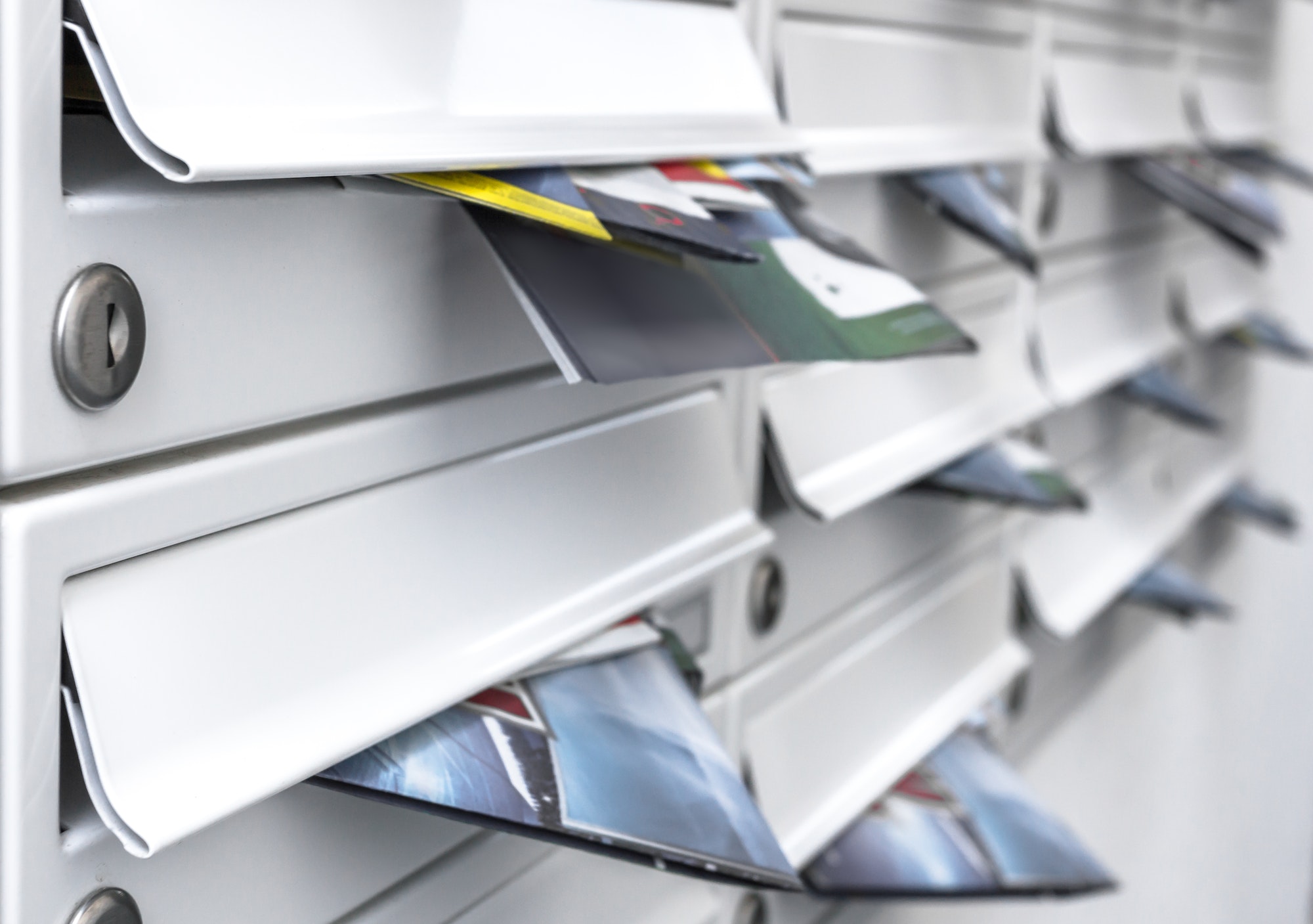 Modern mailboxes filled of flyers