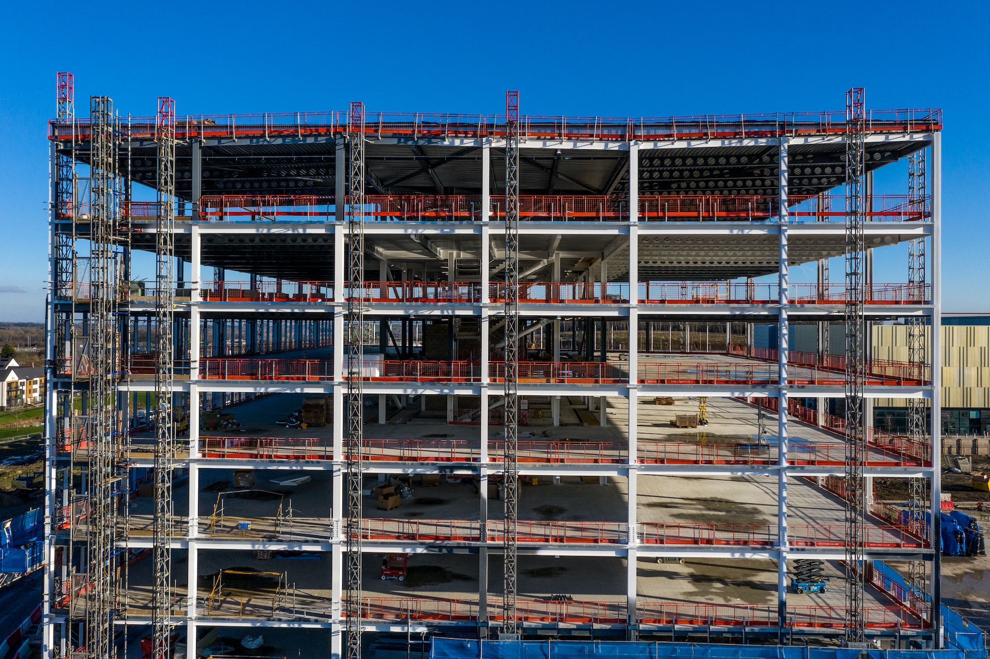 The steel framework of a tall building on a construction site during a new build tower block
