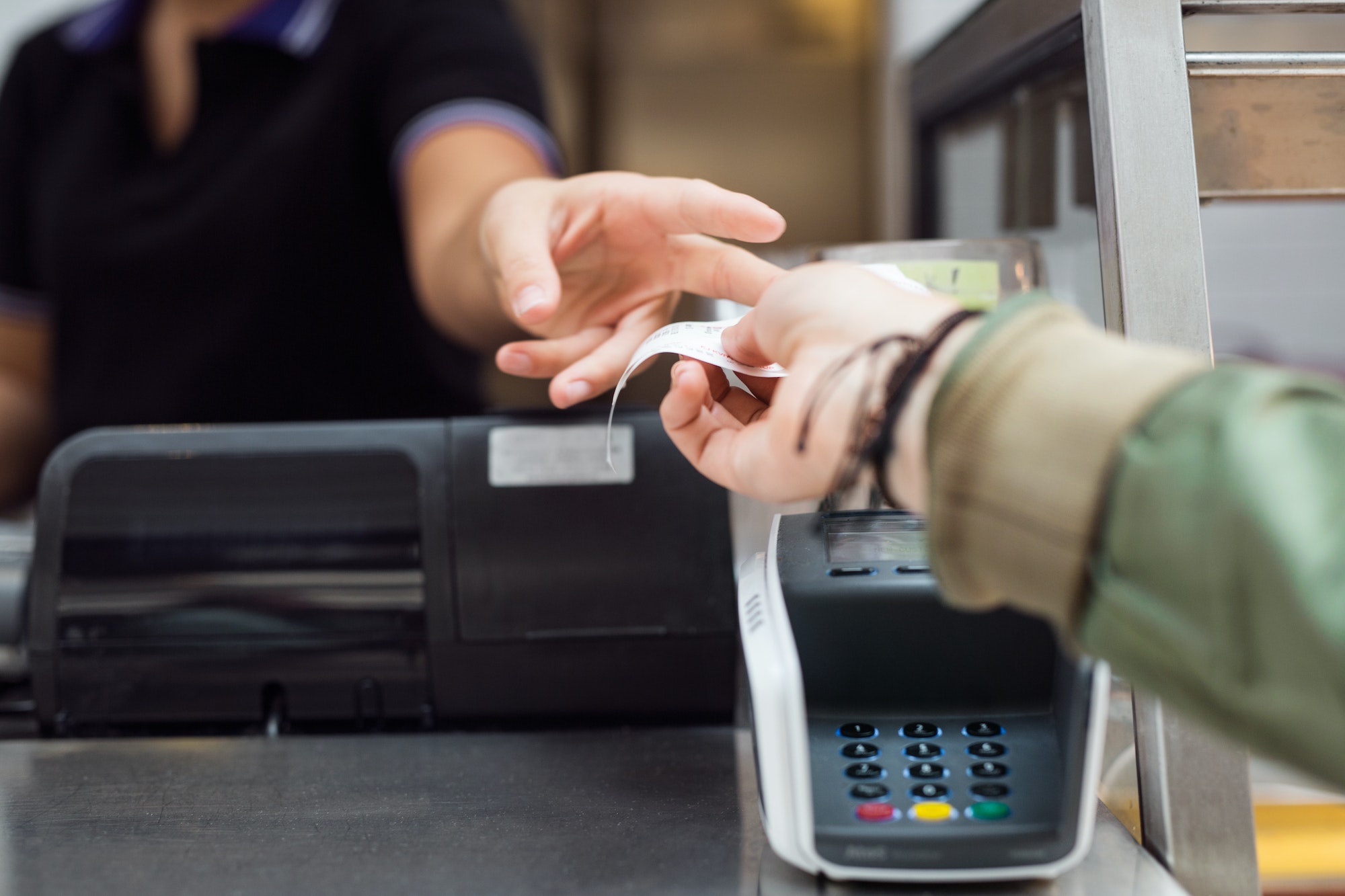 Woman taking receipt at checkout counter