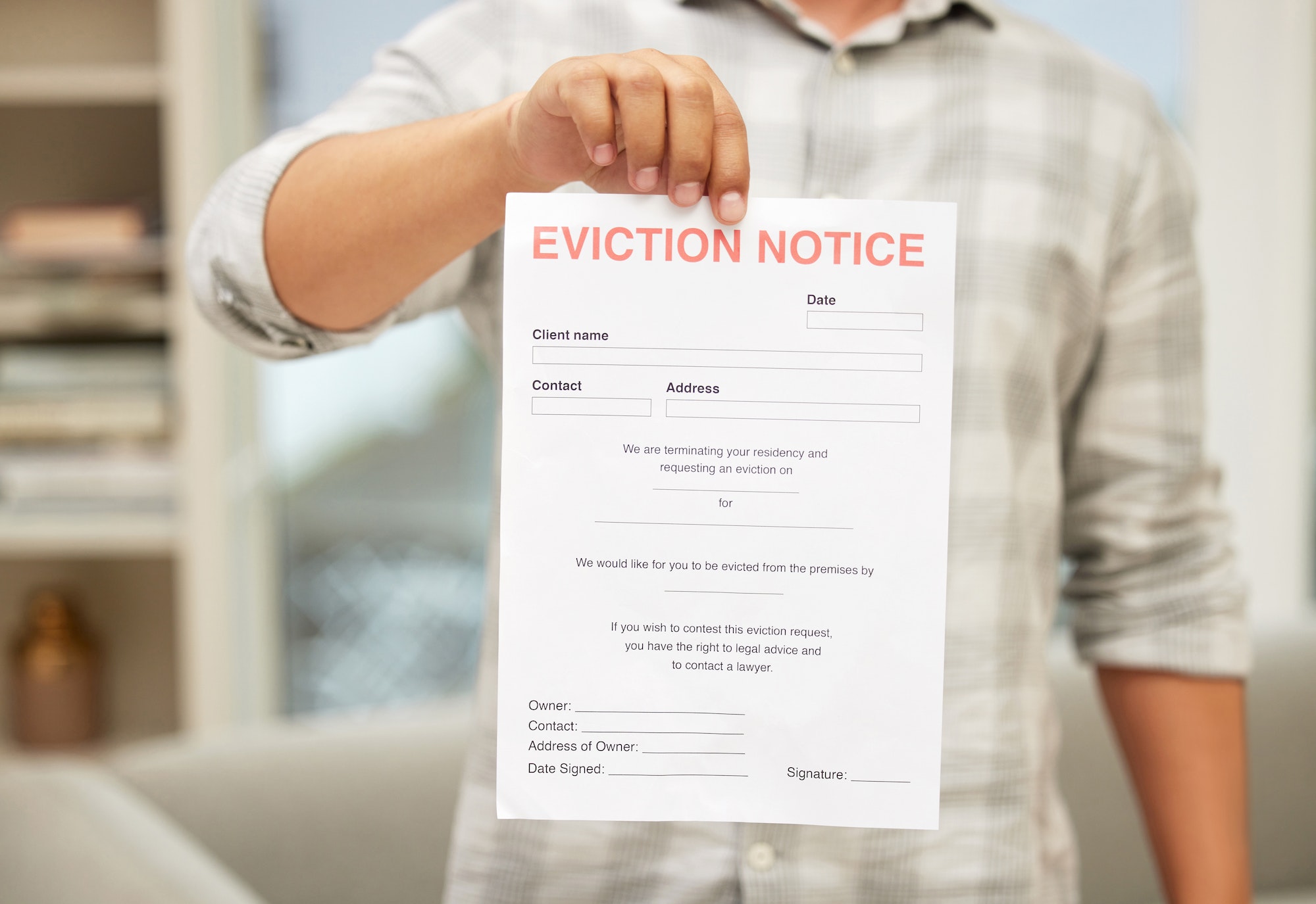 Youre outta here. Shot of an unrecognizable man holding an eviction notice.